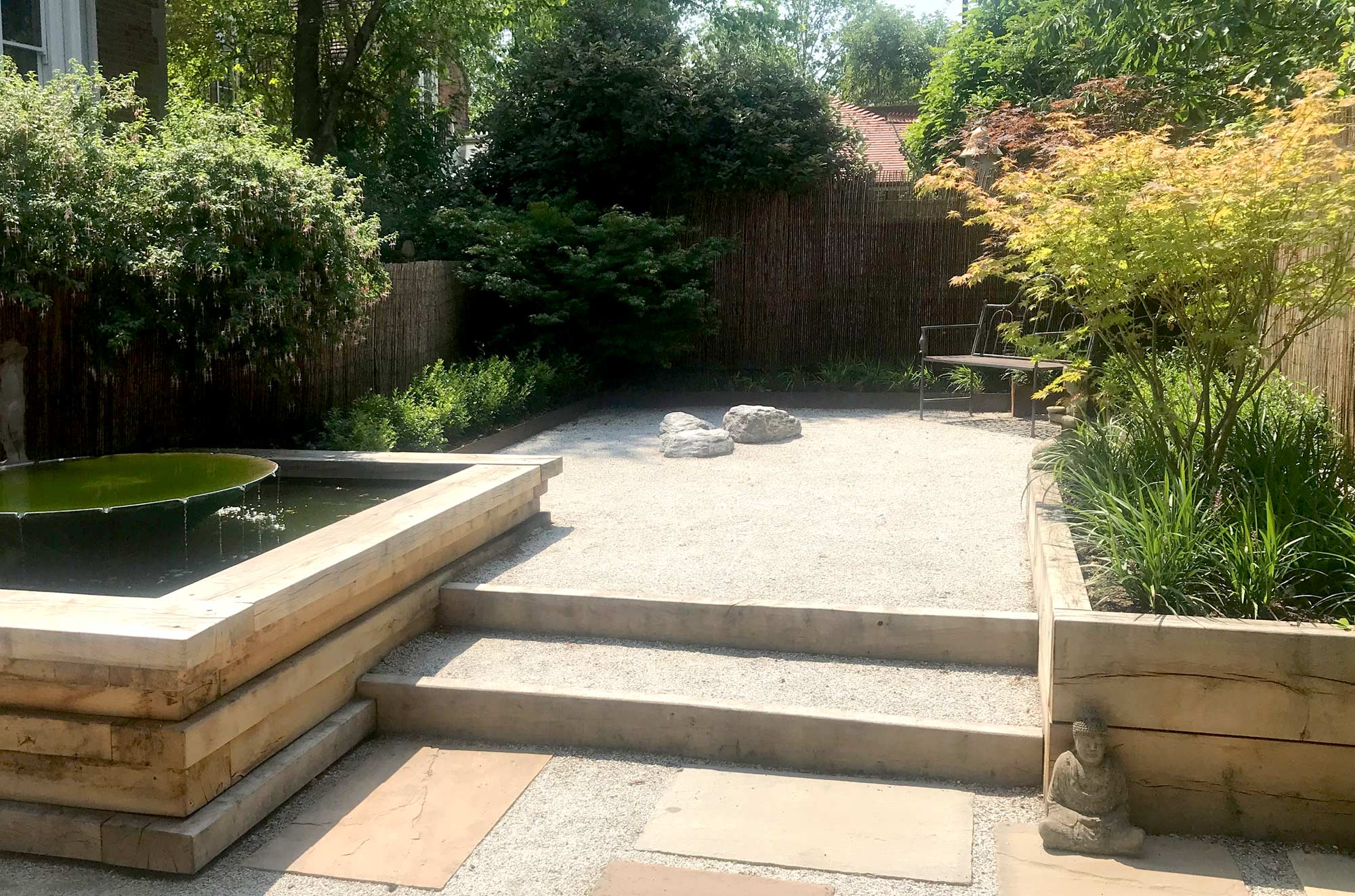 A simple space of rolled gravel and oak layered edgings in a small Windsor garden designed by Peter Eustance copy